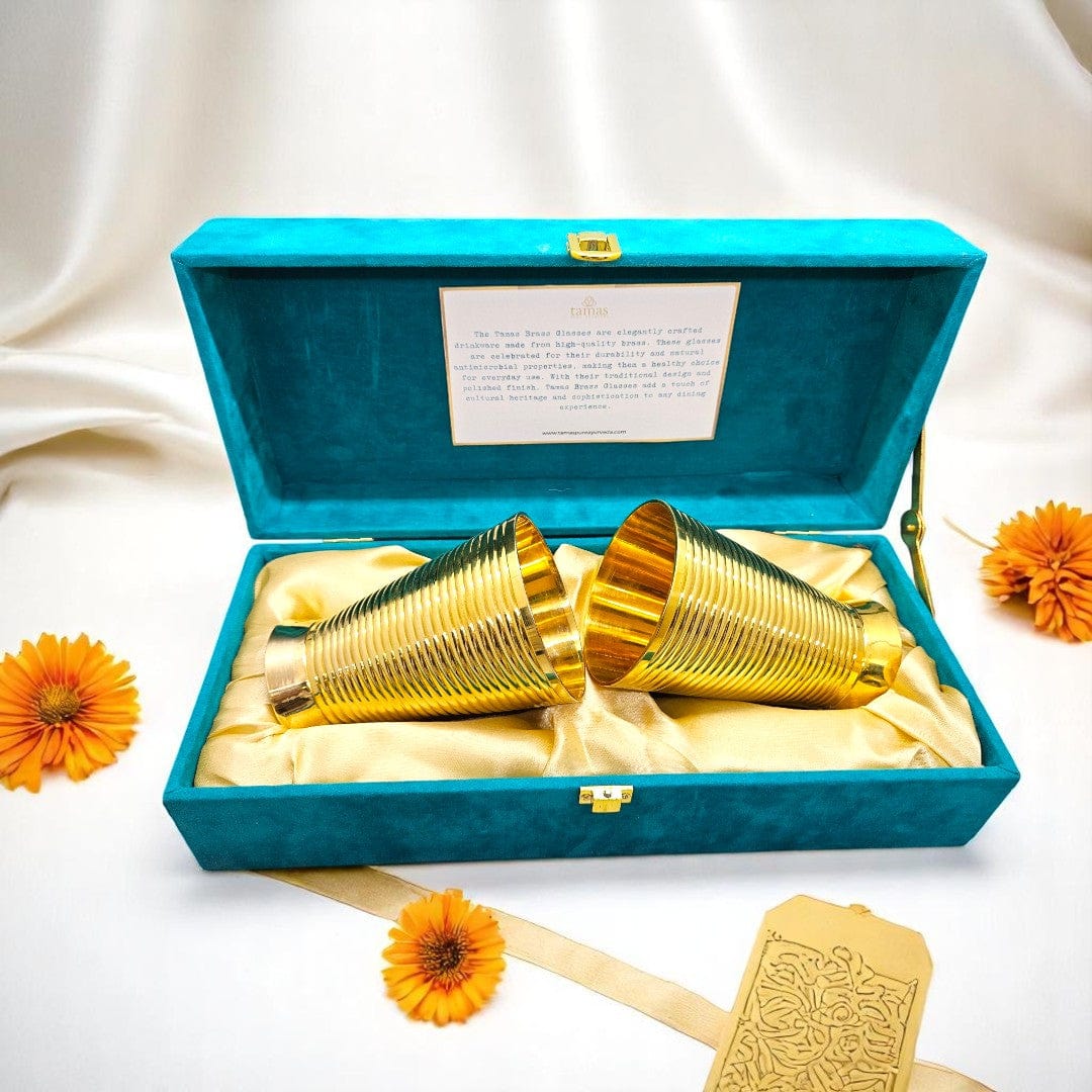 Handcrafted brass glasses in teal velvet box with golden satin lining – premium traditional Indian drinkware set by Tamas