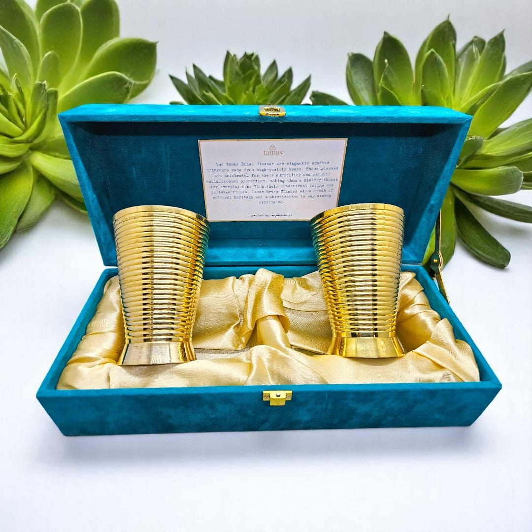 Handcrafted brass glasses in teal velvet box with golden satin lining – premium traditional Indian drinkware set by Tamas