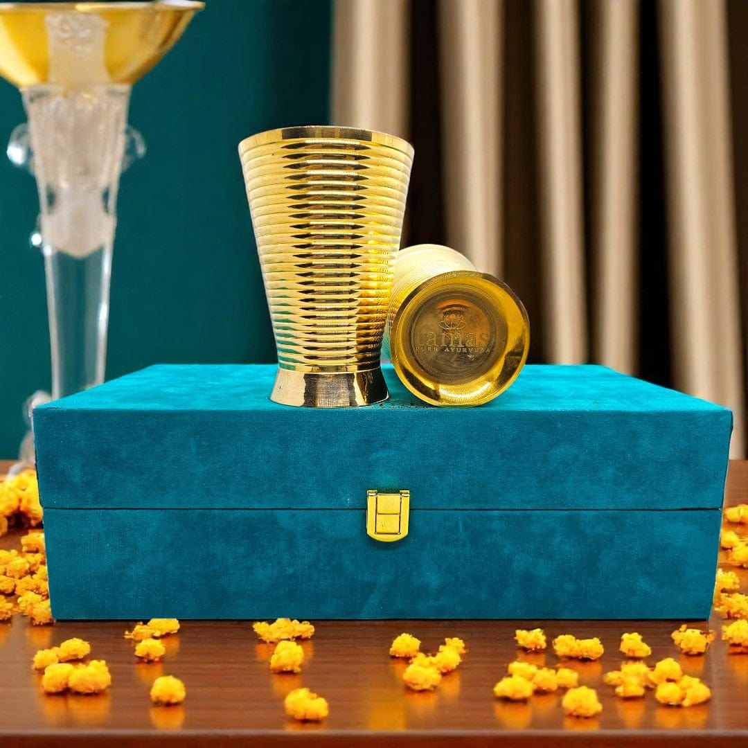 Handcrafted brass glasses in teal velvet box with golden satin lining – premium traditional Indian drinkware set by Tamas
