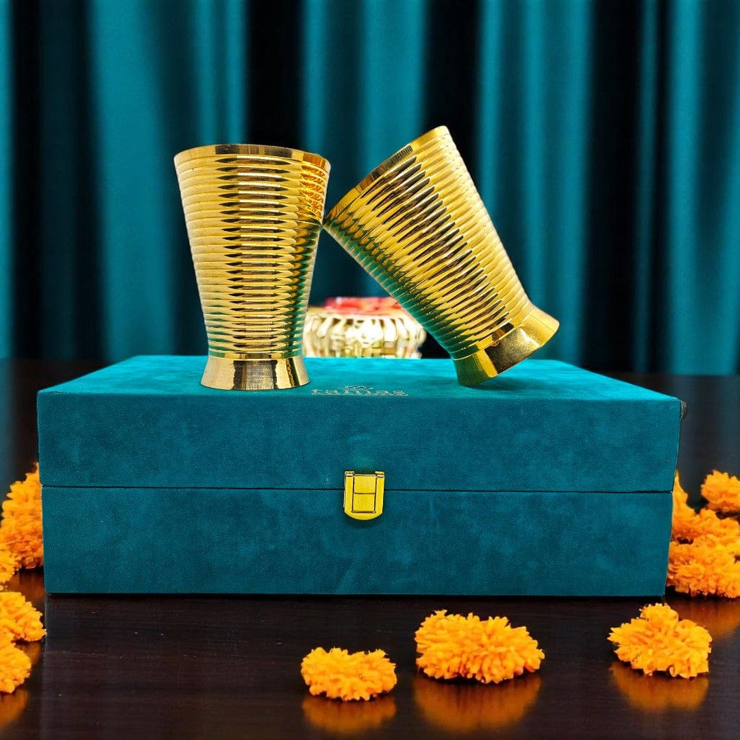 Handcrafted brass glasses in teal velvet box with golden satin lining – premium traditional Indian drinkware set by Tamas